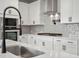 Close-up of kitchen featuring quartz countertop, stainless steel appliances, and white cabinets at 1783 Juniper Berry Way, Loganville, GA 30052