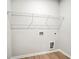 A convenient laundry room with a wire shelf and utility connections at 1783 Juniper Berry Way, Loganville, GA 30052