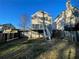 View of the back of the house, with a deck and a spacious, fenced backyard at 3210 Linden Dr, Lawrenceville, GA 30044