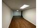 Unfinished basement space with hardwood floors, ideal for storage or future finishing at 3210 Linden Dr, Lawrenceville, GA 30044