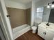 Modern bathroom with a tub, updated vanity and fixtures, plus tile accents at 3210 Linden Dr, Lawrenceville, GA 30044