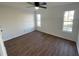 Bright bedroom features hardwood floors, ceiling fan, and natural light from two windows at 3210 Linden Dr, Lawrenceville, GA 30044