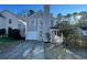 Charming two-story home featuring a covered front porch, attached garage and manicured lawn at 3210 Linden Dr, Lawrenceville, GA 30044