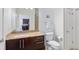 Bright bathroom with modern vanity, granite countertops, and view to kitchen at 870 Inman Village Ne Pkwy # 229, Atlanta, GA 30307