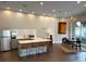 Kitchen with stainless steel appliances, modern bar seating, and a dining table at 870 Inman Village Ne Pkwy # 229, Atlanta, GA 30307