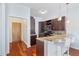 Open kitchen features dark cabinets, granite countertops, a breakfast bar, and stainless steel appliances at 870 Inman Village Ne Pkwy # 229, Atlanta, GA 30307