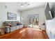 Living room with hardwood floors, ceiling fan, and glass doors to private patio at 870 Inman Village Ne Pkwy # 229, Atlanta, GA 30307