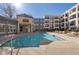 Community pool surrounded by garden beds and patio furniture at 870 Inman Village Ne Pkwy # 229, Atlanta, GA 30307