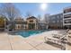 Community pool surrounded by garden beds and patio furniture at 870 Inman Village Ne Pkwy # 229, Atlanta, GA 30307