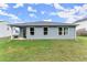Backyard featuring a well-maintained lawn, a privacy fence, and an outdoor seating area at 99 Oxford Ln, Kingston, GA 30145