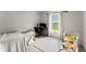 Well-lit bedroom featuring a desk area, comfy bed, and a large window at 99 Oxford Ln, Kingston, GA 30145