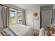 Bright bedroom with a comfortable queen-size bed, natural light, and view of the neighborhood at 99 Oxford Ln, Kingston, GA 30145