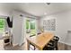 Dining area featuring wood floors, a wooden table, and sliding doors leading to the backyard at 99 Oxford Ln, Kingston, GA 30145