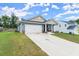 Inviting one-story home featuring an attached two-car garage, covered porch, and neat lawn at 99 Oxford Ln, Kingston, GA 30145