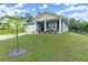 Well-maintained home with a manicured lawn, cozy front porch, and beautiful landscaping at 99 Oxford Ln, Kingston, GA 30145