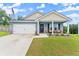Charming single-story home boasts a two-car garage, inviting front porch, and well-manicured lawn at 99 Oxford Ln, Kingston, GA 30145