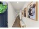 Inviting hallway with wood floors and framed pictures on the wall leading to the living areas at 99 Oxford Ln, Kingston, GA 30145