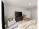 Well-lit main bedroom features a king-size bed, view to the back yard and ample storage space at 99 Oxford Ln, Kingston, GA 30145