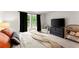 Spacious main bedroom featuring a king-size bed, large windows, and ample natural light at 99 Oxford Ln, Kingston, GA 30145