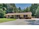 Charming ranch-style home with a well-manicured lawn, lovely landscaping, and a long driveway at 11953 Brown Bridge Rd, Covington, GA 30016