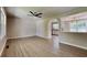Spacious living room with modern ceiling fan and wood-look flooring, flowing into kitchen area at 11953 Brown Bridge Rd, Covington, GA 30016