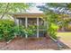 Backyard featuring flower bushes by a screened porch at 2318 Chancery Mill Ln, Buford, GA 30519