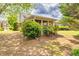 Backyard with greenery featuring flower bushes, screened porch and partial home exterior at 2318 Chancery Mill Ln, Buford, GA 30519