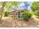Home exterior featuring back screened porch, some greenery and shade at 2318 Chancery Mill Ln, Buford, GA 30519