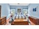 A bedroom with blue walls, a vaulted ceiling, wood floors, large windows, a ceiling fan, and a bed at 2318 Chancery Mill Ln, Buford, GA 30519