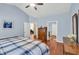 A bedroom with blue walls, wood floors, and a door to the bath and walk-in closet at 2318 Chancery Mill Ln, Buford, GA 30519