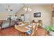 Open dining room featuring hardwood floors, ceiling fan, and views into the living room at 2318 Chancery Mill Ln, Buford, GA 30519