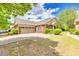Charming brick home with a well-manicured lawn and an attached two-car garage at 2318 Chancery Mill Ln, Buford, GA 30519