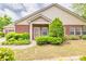 Home exterior with landscaping, lush green bushes, brick facade and front door at 2318 Chancery Mill Ln, Buford, GA 30519