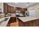A kitchen featuring dark cabinets, stainless steel appliances, an island with countertops, and neutral tile backsplash at 2318 Chancery Mill Ln, Buford, GA 30519