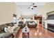 Spacious living room with hardwood floors, fireplace, and a ceiling fan at 2318 Chancery Mill Ln, Buford, GA 30519