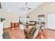 Open-concept living room with a fireplace, ceiling fan, and hardwood flooring at 2318 Chancery Mill Ln, Buford, GA 30519