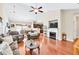 Spacious living room with hardwood floors, fireplace, ceiling fan, and comfortable seating area at 2318 Chancery Mill Ln, Buford, GA 30519