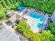 An aerial shot of the community pool with lounge chairs and shady pavilions at 2318 Chancery Mill Ln, Buford, GA 30519