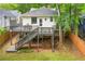 Exterior of home with a large deck and spacious backyard surrounded by trees at 291 Elmira Ne Pl, Atlanta, GA 30307