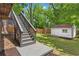 Backyard featuring a storage shed and stairs leading from the house above at 291 Elmira Ne Pl, Atlanta, GA 30307