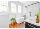 Sun-filled bathroom featuring a soaker tub, glass shower and modern vanity at 291 Elmira Ne Pl, Atlanta, GA 30307