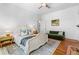 Bright bedroom with original hardwood floors and a green couch at 291 Elmira Ne Pl, Atlanta, GA 30307