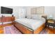 Bright bedroom featuring a wood bed frame, modern accents and an eye-catching area rug at 291 Elmira Ne Pl, Atlanta, GA 30307