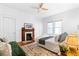 Cozy bedroom with a decorative fireplace, ceiling fan and natural light at 291 Elmira Ne Pl, Atlanta, GA 30307