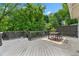 Large wood deck with a dining table, chairs and a privacy screen backdrop at 291 Elmira Ne Pl, Atlanta, GA 30307