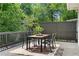 Wooden deck featuring an outdoor dining set and beautiful surrounding trees at 291 Elmira Ne Pl, Atlanta, GA 30307