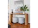 Stylish entryway features a modern console table with floral upholstered stools and hardwood flooring at 291 Elmira Ne Pl, Atlanta, GA 30307