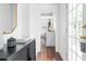 Bright hallway featuring a white color scheme with a view of the kitchen and an open doorway to the front porch at 291 Elmira Ne Pl, Atlanta, GA 30307