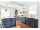 Stylish kitchen featuring navy cabinets, sleek countertops, and modern fixtures offering a perfect blend of elegance and functionality at 291 Elmira Ne Pl, Atlanta, GA 30307