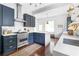 Modern kitchen with navy cabinets, stainless steel appliances, and island with white countertop, blending style and functionality at 291 Elmira Ne Pl, Atlanta, GA 30307
